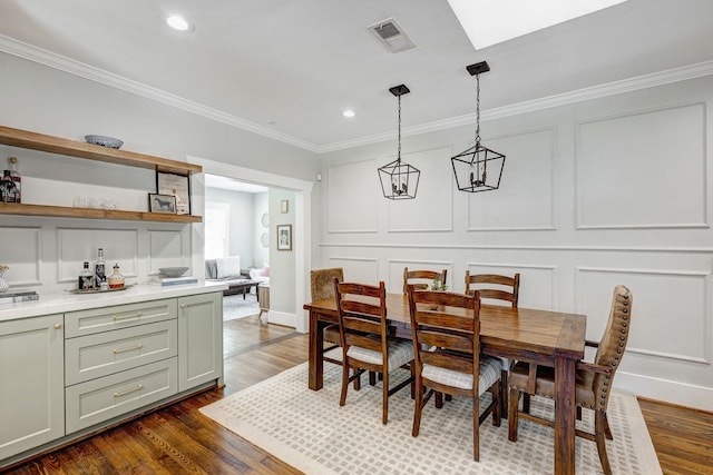 3708 Watson St, Houston, TX 77009 - dining area featuring a decorative wall, ornamental molding, dark wood-style flooring, and recessed lighting
