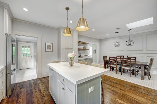 3708 Watson St, Houston, TX 77009 - kitchen featuring a skylight, high end refrigerator, dark wood-style flooring, crown molding, and open shelves