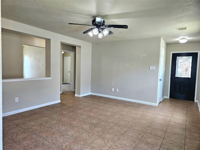 20731 Cypress Post Dr, Cypress, TX 77433 - spare room with a textured ceiling, ceiling fan, baseboards, and tile patterned floors