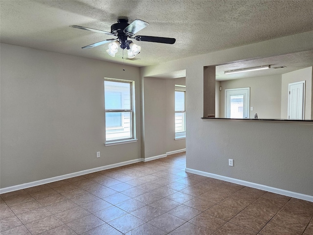 20731 Cypress Post Dr, Cypress, TX 77433 - tiled empty room featuring a textured ceiling, ceiling fan, and baseboards