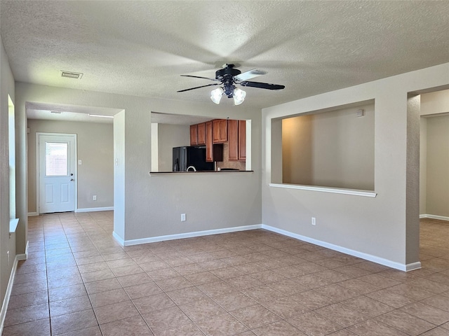 20731 Cypress Post Dr, Cypress, TX 77433 - unfurnished living room with a ceiling fan, a textured ceiling, light tile patterned flooring, and baseboards