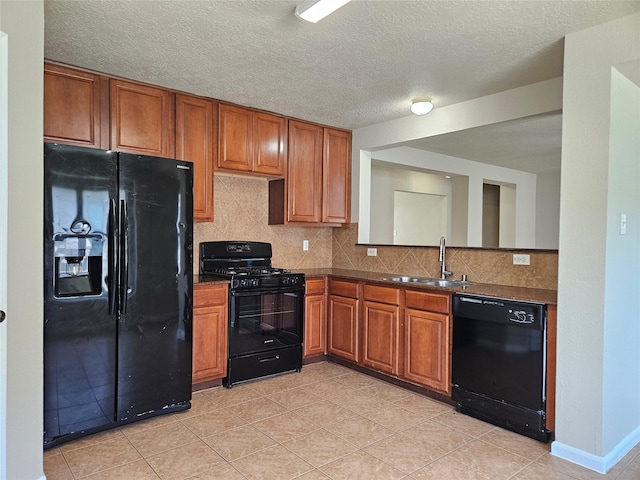 20731 Cypress Post Dr, Cypress, TX 77433 - kitchen featuring black appliances, a sink, brown cabinetry, dark countertops, and a textured ceiling