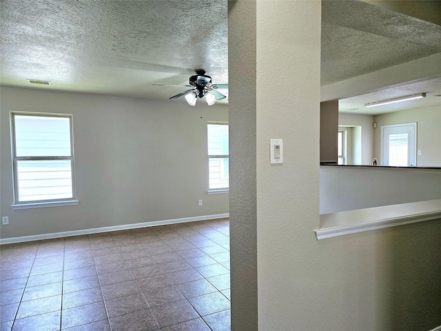 20731 Cypress Post Dr, Cypress, TX 77433 - spare room with a textured ceiling, ceiling fan, a textured wall, baseboards, and tile patterned flooring