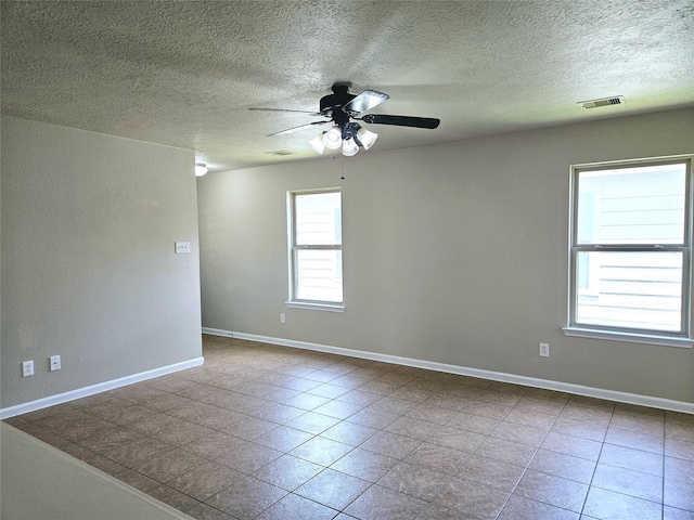 20731 Cypress Post Dr, Cypress, TX 77433 - tiled empty room with ceiling fan, a textured ceiling, and baseboards