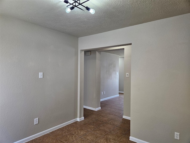 20731 Cypress Post Dr, Cypress, TX 77433 - spare room featuring dark tile patterned floors, a textured ceiling, and baseboards