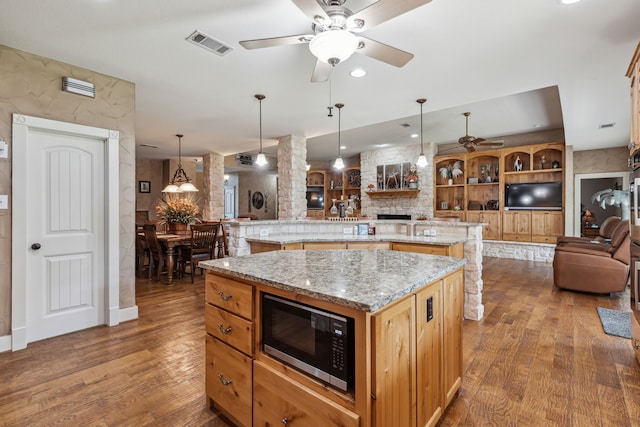 4430 Fm 546, Princeton, TX 75407 - kitchen featuring stainless steel microwave, ceiling fan, a large island, open floor plan, and wood finished floors