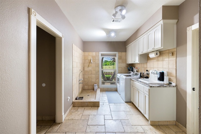 4430 Fm 546, Princeton, TX 75407 - laundry area with washer and clothes dryer, baseboards, and stone tile flooring