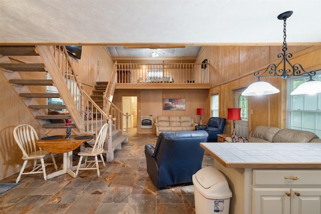 4430 Fm 546, Princeton, TX 75407 - living area featuring wooden walls, plenty of natural light, stone tile floors, and stairway
