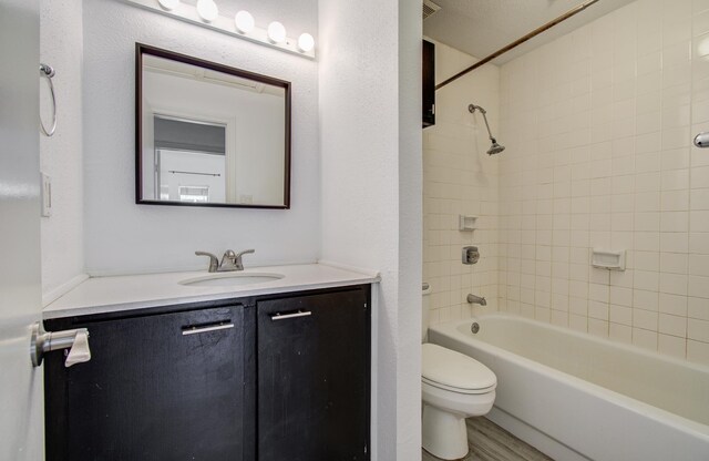 716 Bering Dr Unit 30, Houston, TX 77057 - bathroom featuring toilet, vanity, bathtub / shower combination, and wood finished floors