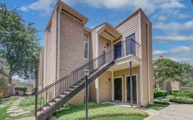 716 Bering Dr Unit 30, Houston, TX 77057 - back of house with stairway, brick siding, and a balcony