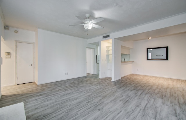 716 Bering Dr Unit 30, Houston, TX 77057 - unfurnished living room with ceiling fan, light wood-style floors, a sink, and baseboards