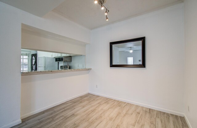 716 Bering Dr Unit 30, Houston, TX 77057 - unfurnished room featuring wood finished floors, baseboards, a ceiling fan, and rail lighting