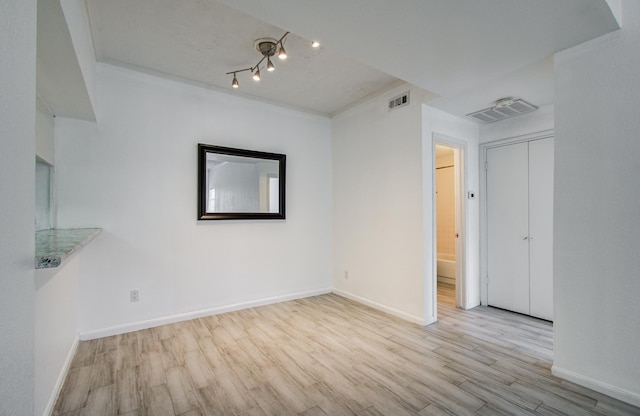 716 Bering Dr Unit 30, Houston, TX 77057 - unfurnished room with wood finished floors, baseboards, and track lighting