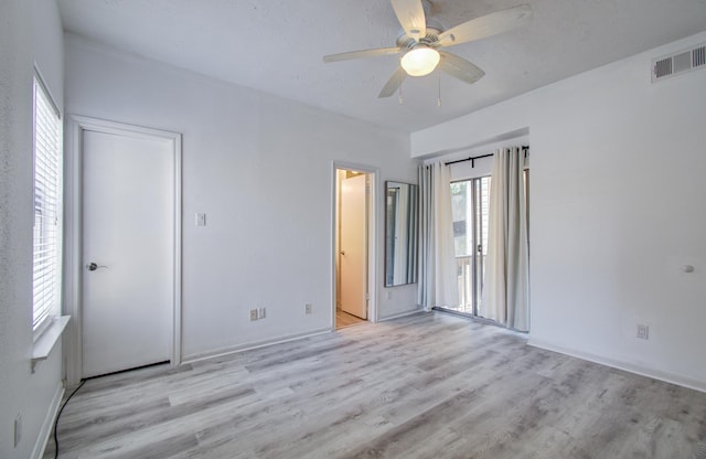 716 Bering Dr Unit 30, Houston, TX 77057 - unfurnished bedroom with light wood-style flooring, ceiling fan, and baseboards