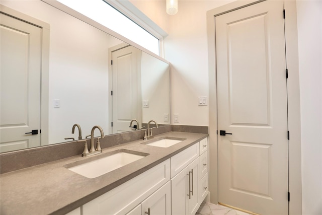 510 E 37th St, Houston, TX 77022 - bathroom featuring double vanity and marble look tiles