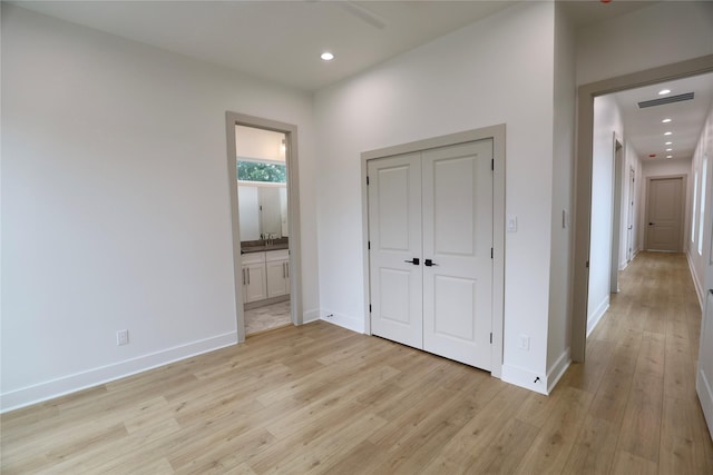 510 E 37th St, Houston, TX 77022 - unfurnished bedroom with light wood-style floors, recessed lighting, ensuite bathroom, and baseboards
