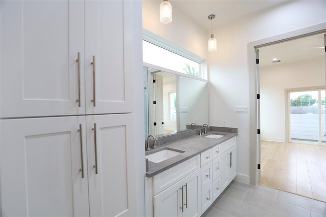 510 E 37th St, Houston, TX 77022 - bathroom with double vanity, tile patterned flooring, and baseboards