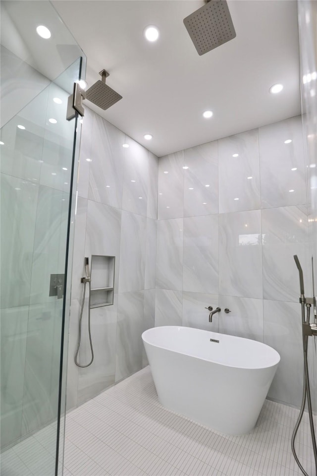 510 E 37th St, Houston, TX 77022 - full bath with a stall shower, tile walls, a soaking tub, tile patterned flooring, and recessed lighting