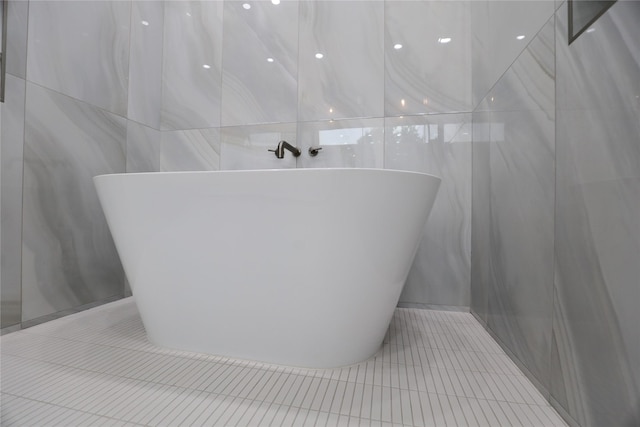 510 E 37th St, Houston, TX 77022 - full bathroom featuring tile walls, tile patterned flooring, and a freestanding bath