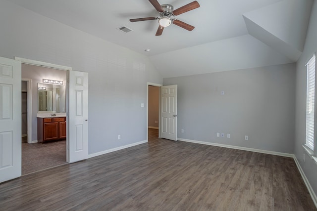 13035 Echo Landing Dr, Houston, TX 77070 - unfurnished bedroom featuring dark wood finished floors, lofted ceiling, baseboards, and multiple windows