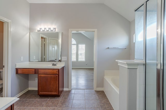 13035 Echo Landing Dr, Houston, TX 77070 - bathroom featuring lofted ceiling, vanity, a garden tub, toilet, and tile patterned flooring