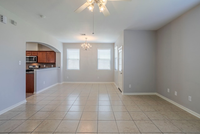 13035 Echo Landing Dr, Houston, TX 77070 - unfurnished living room featuring a chandelier, a ceiling fan, light tile patterned floors, and baseboards