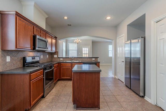13035 Echo Landing Dr, Houston, TX 77070 - kitchen with stainless steel appliances, a sink, dark countertops, arched walkways, and tasteful backsplash