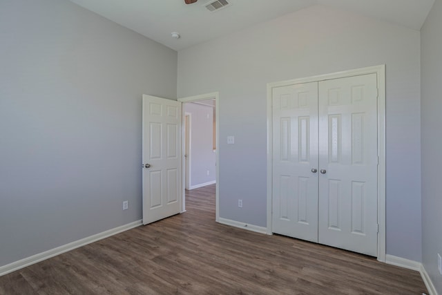 13035 Echo Landing Dr, Houston, TX 77070 - unfurnished bedroom with dark wood-type flooring, baseboards, a closet, and high vaulted ceiling
