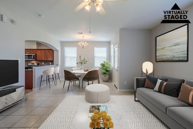 13035 Echo Landing Dr, Houston, TX 77070 - living area with a chandelier, light tile patterned flooring, a ceiling fan, and baseboards