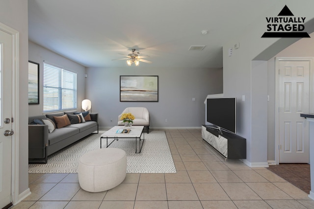 13035 Echo Landing Dr, Houston, TX 77070 - living room with light tile patterned flooring, ceiling fan, and baseboards