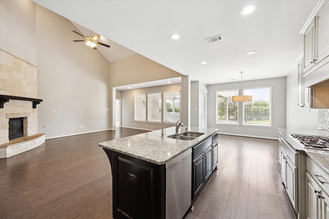 6406 Diamantina Ct, Katy, TX 77493 - kitchen with a sink, appliances with stainless steel finishes, open floor plan, a ceiling fan, and dark wood finished floors