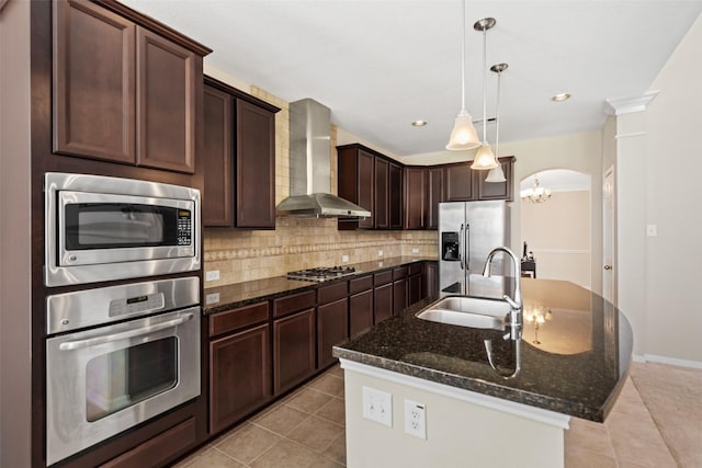 kitchen featuring appliances with stainless steel finishes, wall chimney exhaust hood, a sink, light tile patterned floors, and recessed lighting