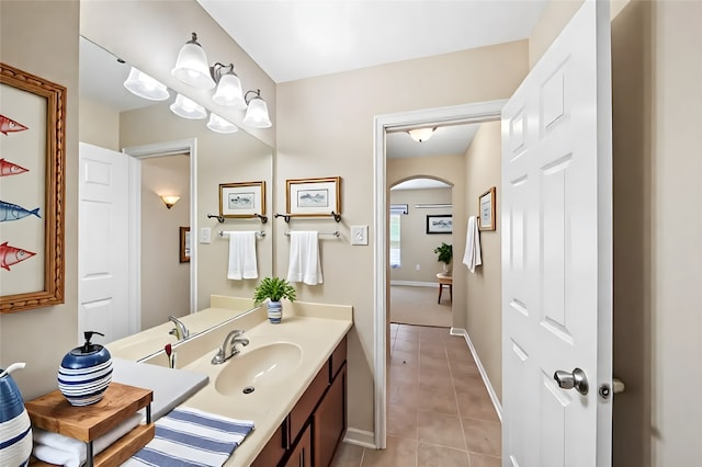 bathroom featuring tile patterned floors, vanity, and baseboards