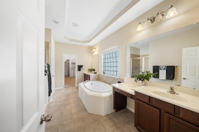 bathroom featuring a shower stall, a garden tub, tile patterned floors, and two vanities