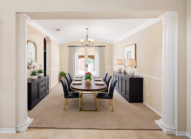 dining area featuring baseboards, lofted ceiling, ornate columns, a chandelier, and light carpet