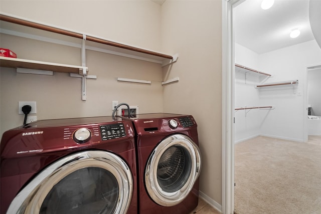 washroom featuring separate washer and dryer, carpet flooring, and baseboards
