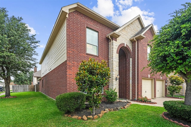 traditional-style house featuring brick siding, a garage, and driveway