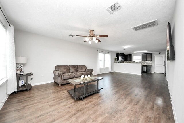 696 Rd 5105, Cleveland, TX 77327 - living area featuring a ceiling fan, dark wood finished floors, baseboards, and a textured ceiling