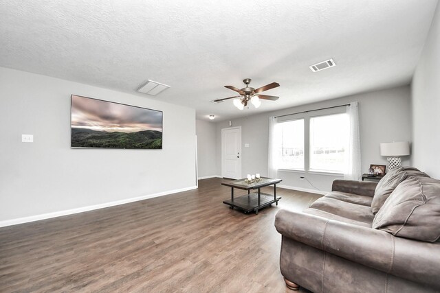 696 Rd 5105, Cleveland, TX 77327 - living room featuring wood finished floors, ceiling fan, baseboards, and a textured ceiling