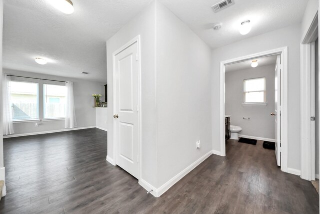 696 Rd 5105, Cleveland, TX 77327 - corridor with dark wood-type flooring, baseboards, and a textured ceiling