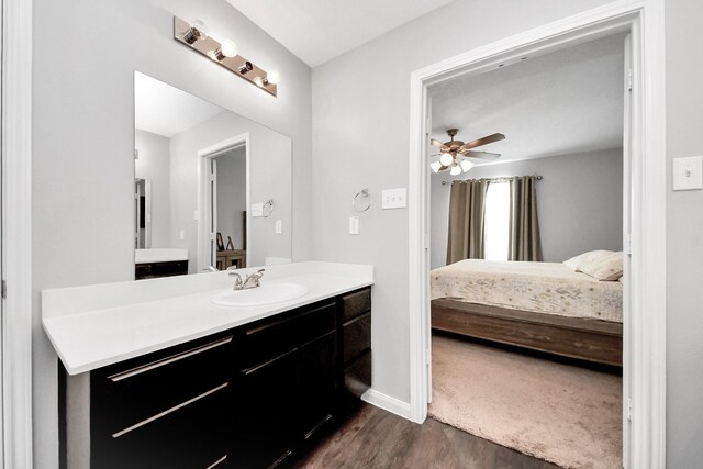 696 Rd 5105, Cleveland, TX 77327 - bathroom with connected bathroom, wood finished floors, ceiling fan, vanity, and baseboards