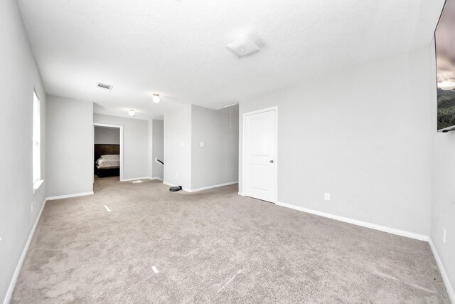 696 Rd 5105, Cleveland, TX 77327 - carpeted spare room with attic access and baseboards