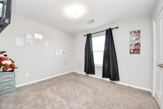 696 Rd 5105, Cleveland, TX 77327 - empty room with carpet, a textured ceiling, and baseboards