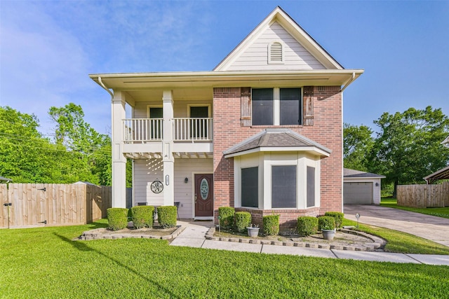 307 Squall Ct, Crosby, TX 77532 - view of front facade featuring a balcony, brick siding, and a detached garage