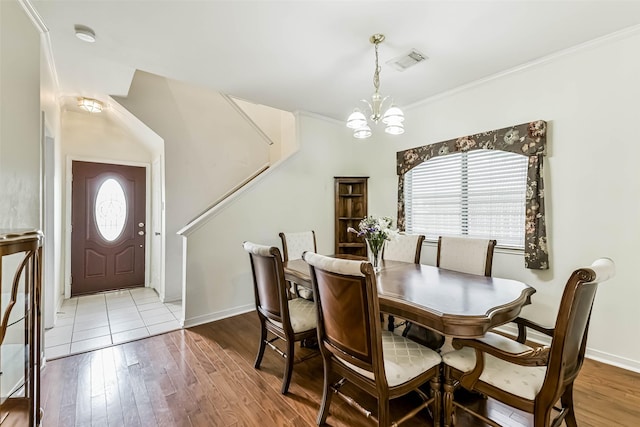307 Squall Ct, Crosby, TX 77532 - dining room featuring a chandelier, wood finished floors, baseboards, and ornamental molding