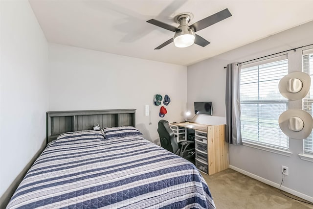 307 Squall Ct, Crosby, TX 77532 - bedroom with light carpet, multiple windows, baseboards, and ceiling fan