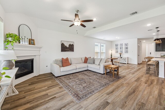 204 Catalina Cove Dr, Katy, TX 77493 - living area featuring light wood-style floors, ceiling fan, a glass covered fireplace, and recessed lighting