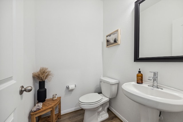 204 Catalina Cove Dr, Katy, TX 77493 - bathroom featuring wood finished floors, toilet, a sink, and baseboards