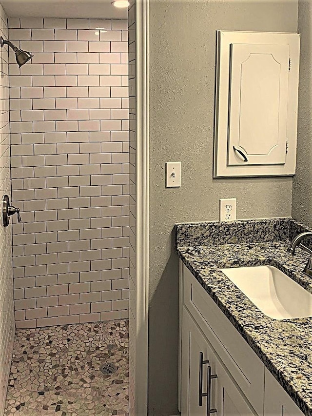 8322 Cabot St, Houston, TX 77078 - bathroom with a stall shower, vanity, and a textured wall