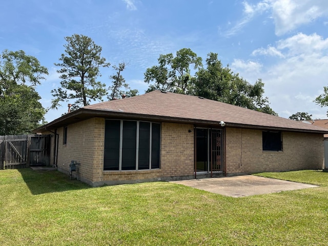 8322 Cabot St, Houston, TX 77078 - rear view of house featuring a patio area, brick siding, a shingled roof, and a gate